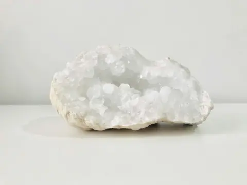 A white crystal geode on a plain white surface