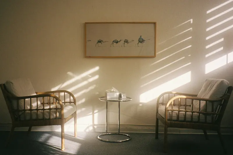 Two empty chairs in a sunlit room