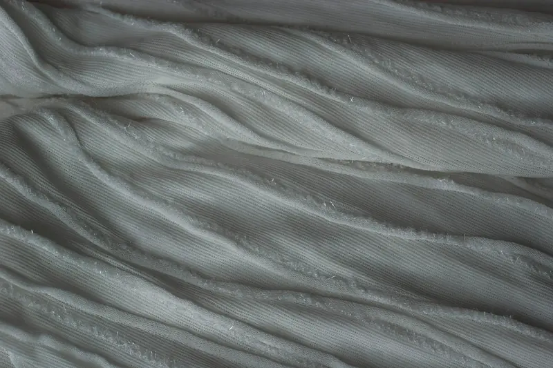 Soft folds in white fabric